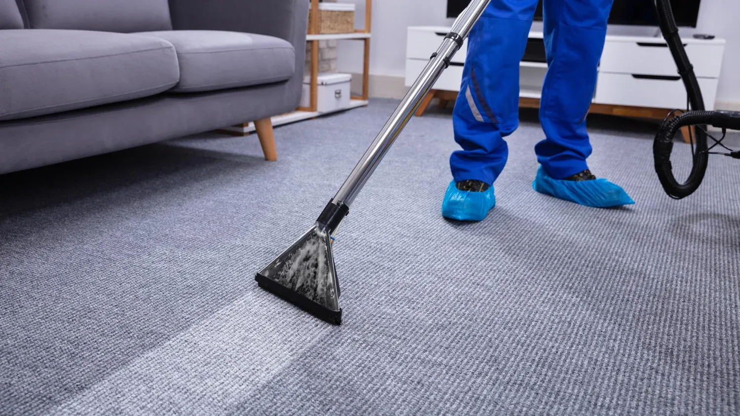 A technician applying dry cleaning powder on a high-traffic carpet to clean without moisture, ensuring quick results.